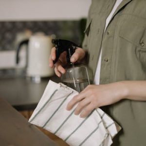 Person in Green Button Up Shirt Holding Clear Drinking Glass